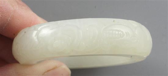 A Chinese white jade bangle or ring, diameter 5.7cm